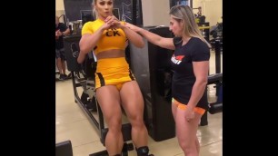 'women fitness model at gym with trainer'